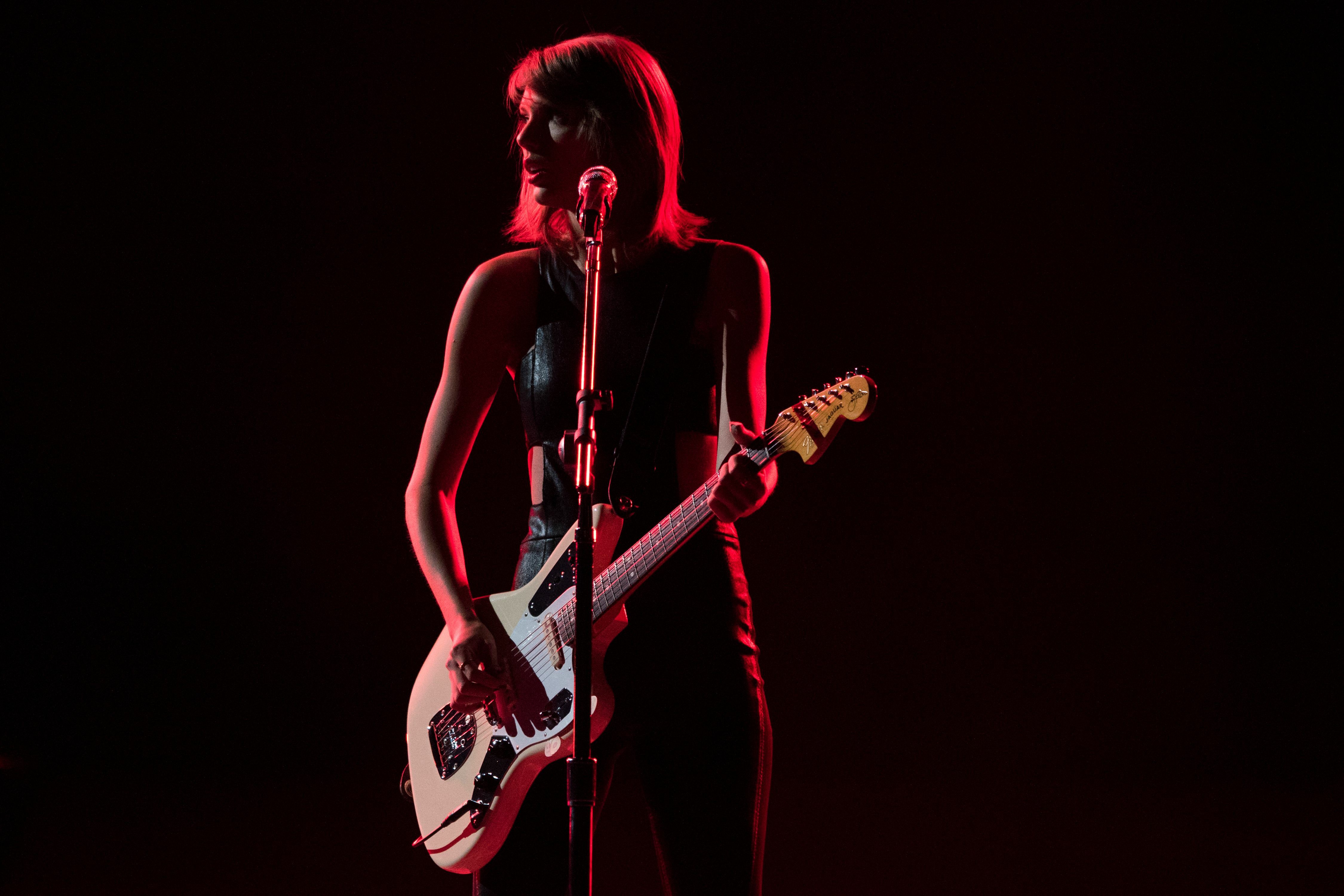 Тейлор музыка. Тейлор Свифт с гитарой на сцене. Тейлор Свифт 1989 концерт. Taylor Swift с гитарой. Тейлор Свифт на сцене.